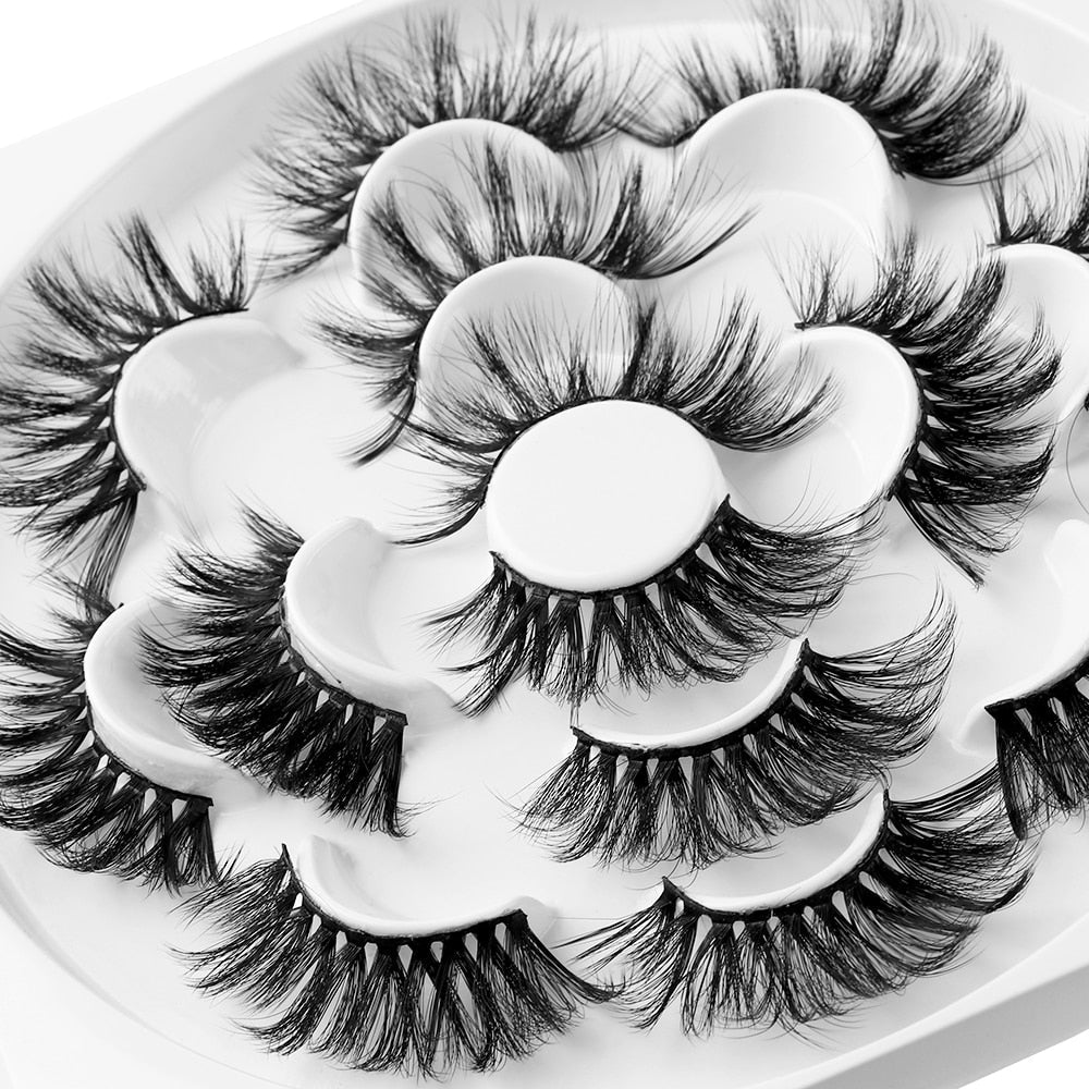 Close-up angled view of multiple lash pairs showing feathered, wispy texture and 3D layering