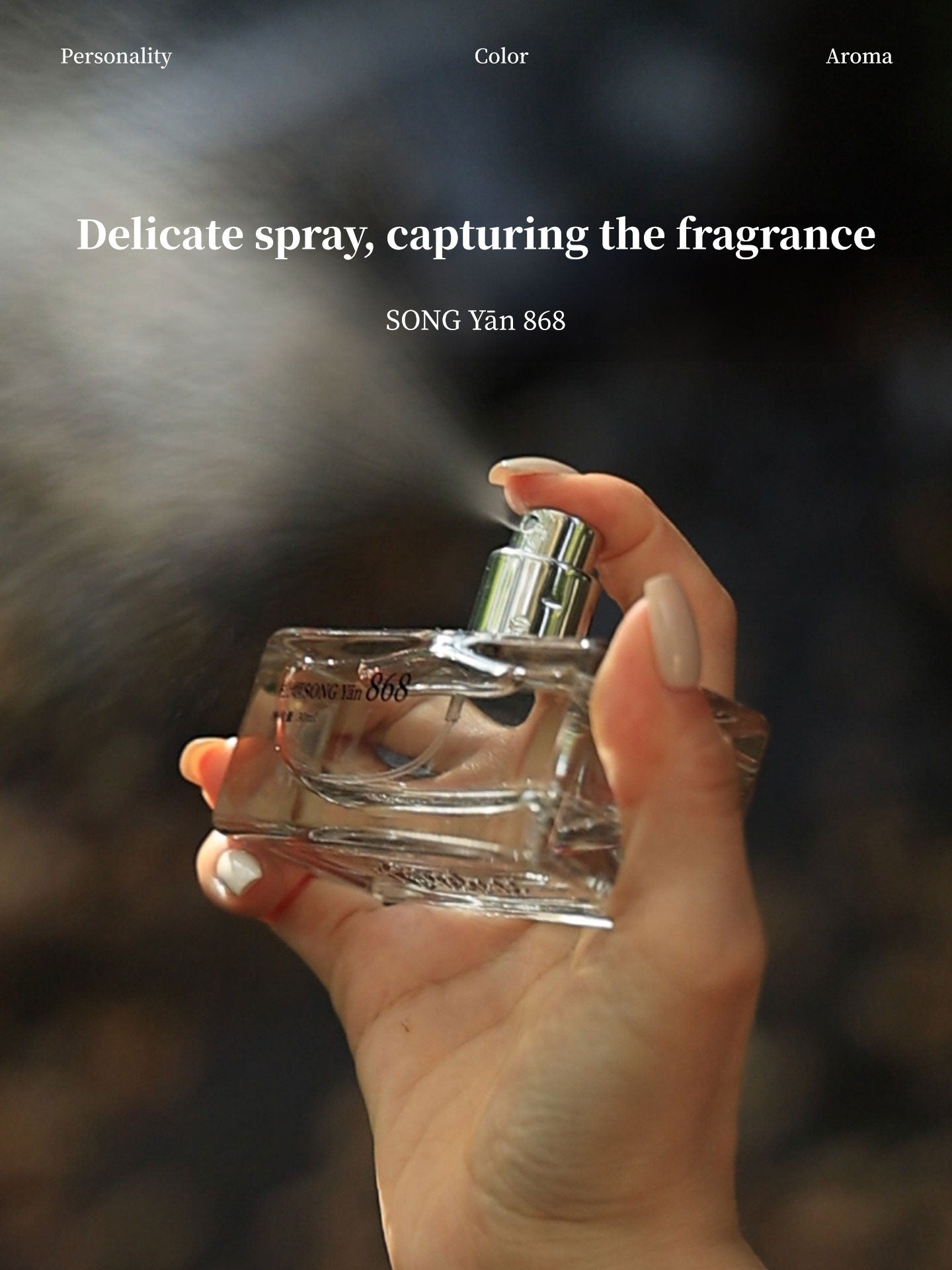 Four fragrance bottles from the collection displayed on moss-covered rocks with waterfall backdrop