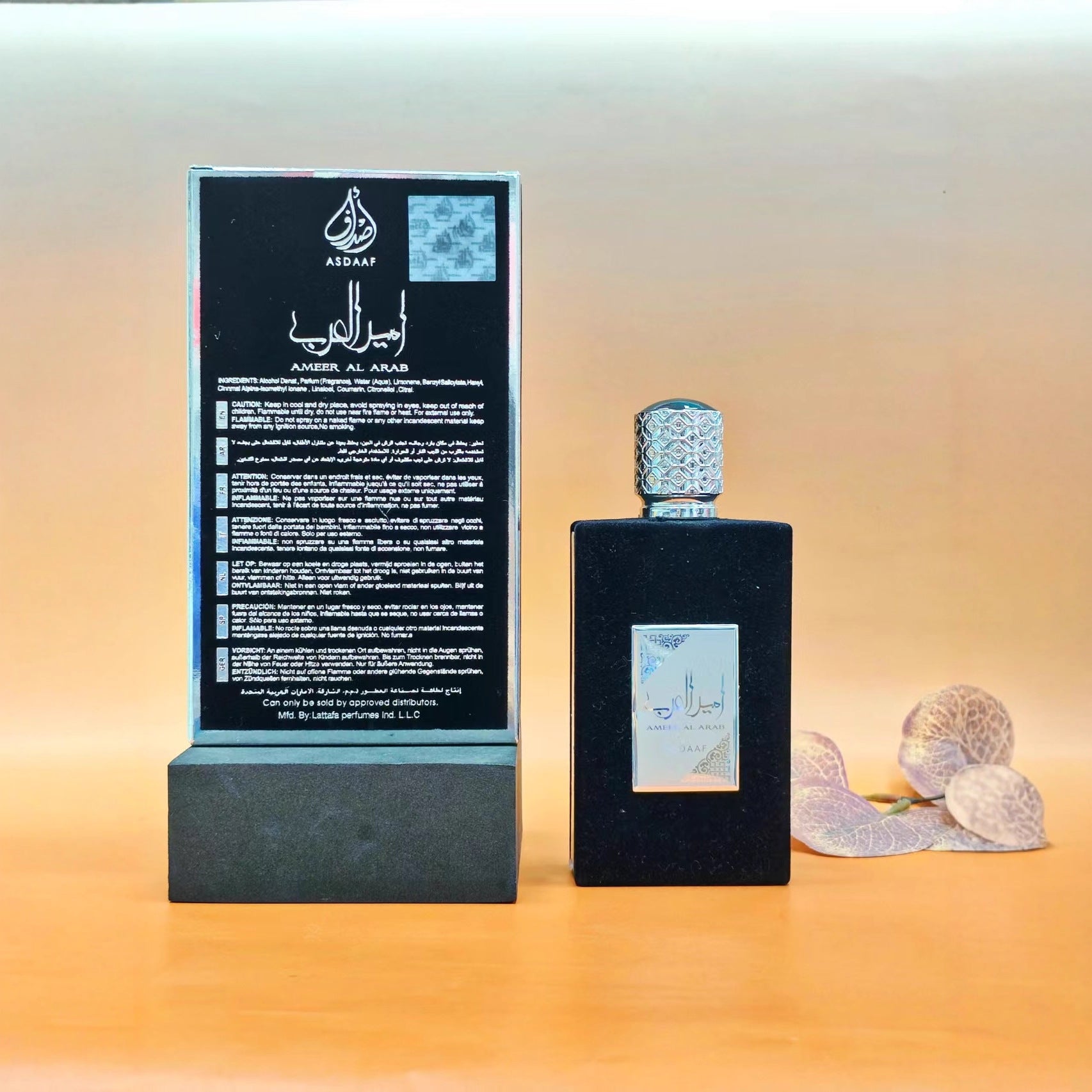 Teal-green variant with gold trim box and bottle, golden cap, displayed in natural sunlit setting with geometric patterns
