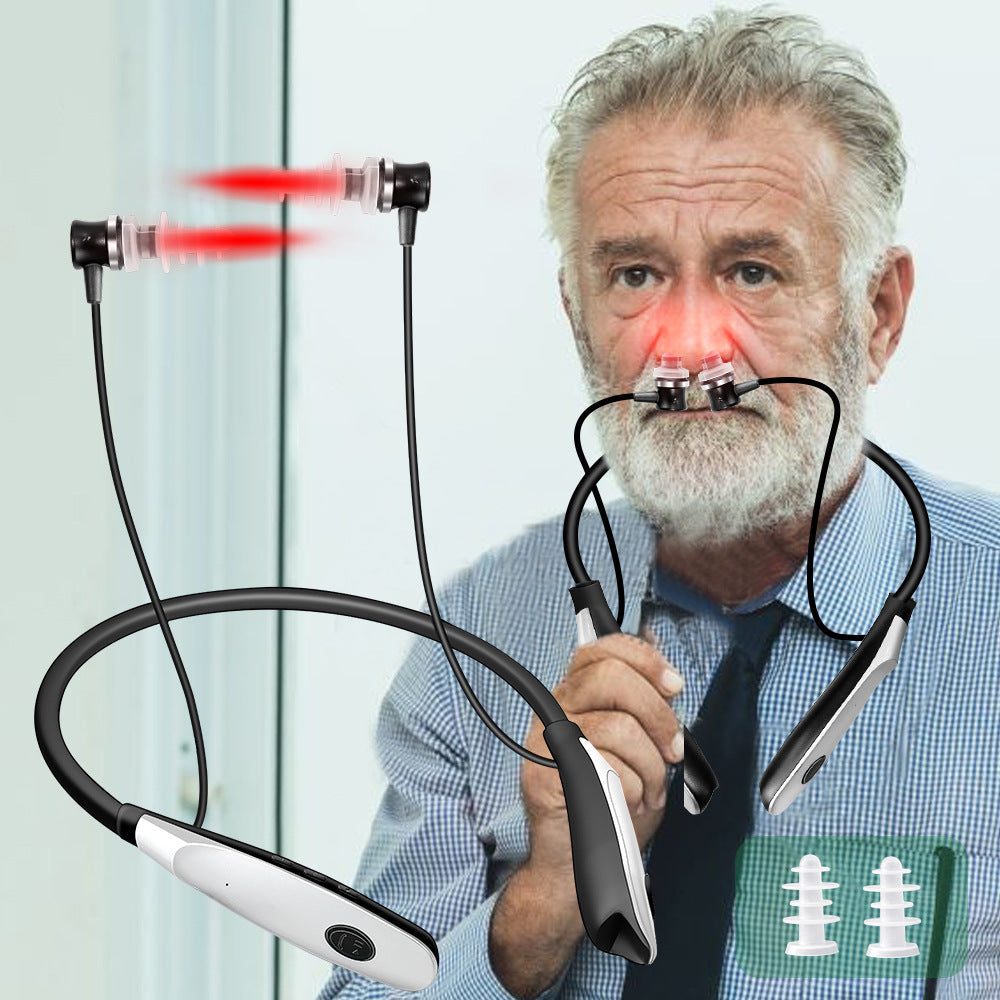 Older male demonstrating nasal laser positioning with visible red light emission from nostril and ear areas