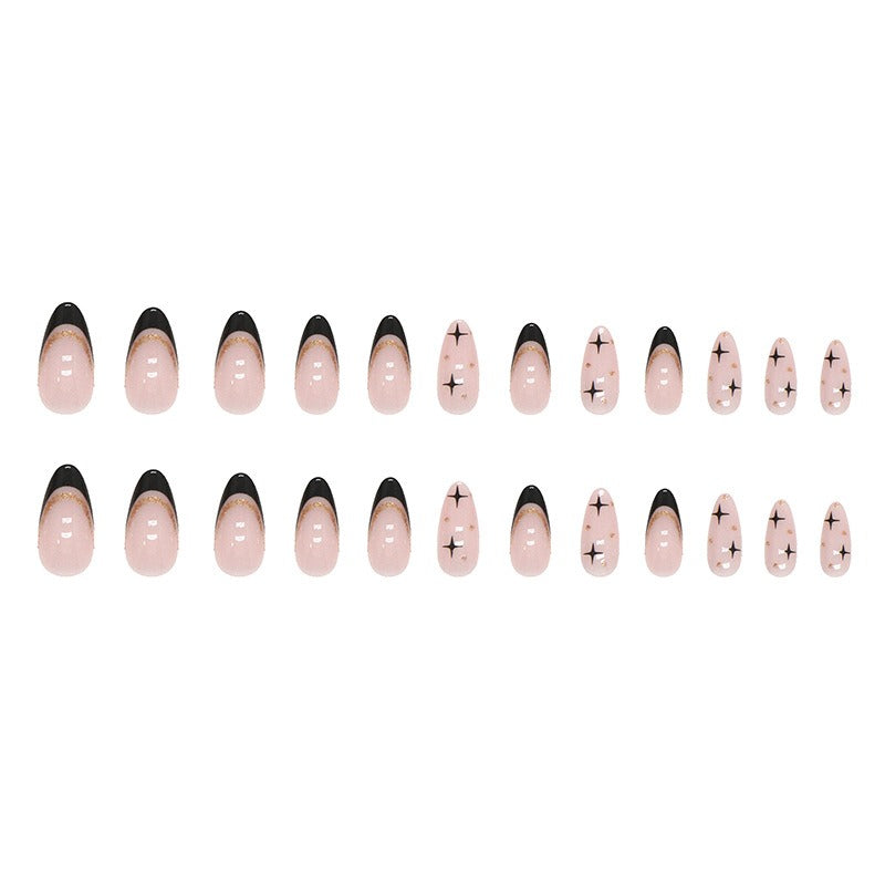 Fan arrangement of individual nail pieces on beige background showing both design variants up close: black French tips with gold glitter line and plain nude nails with black star motifs