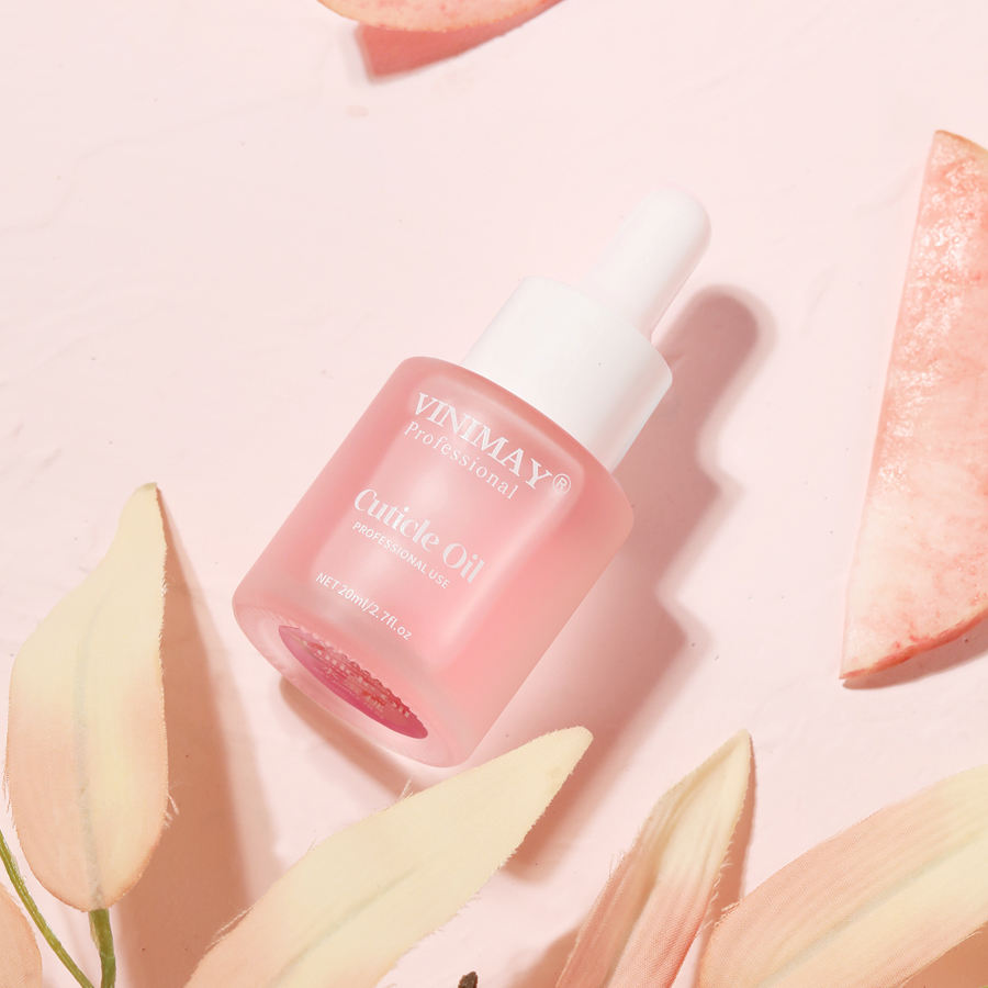 Cuticle oil bottle on textured white surface with avocado ingredient callout and text 'REPAIR DAMAGE Itamin E Strong Repair Nutrient Oil 20ml'