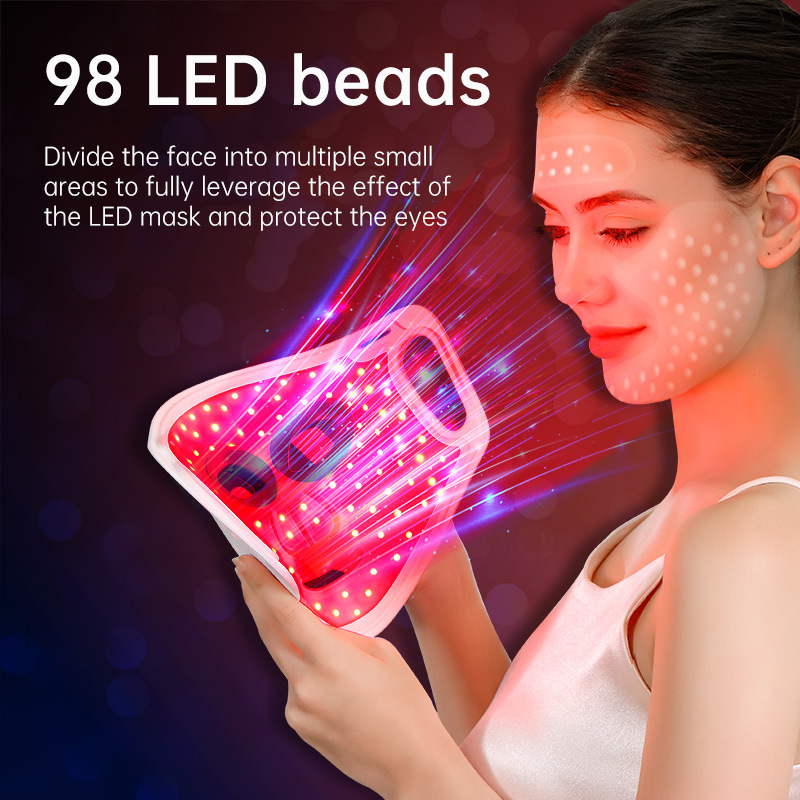 Close-up of LED light mask showing intricate rainbow gradient from green through magenta to red, with white dot LED array pattern and soft translucent silicone construction
