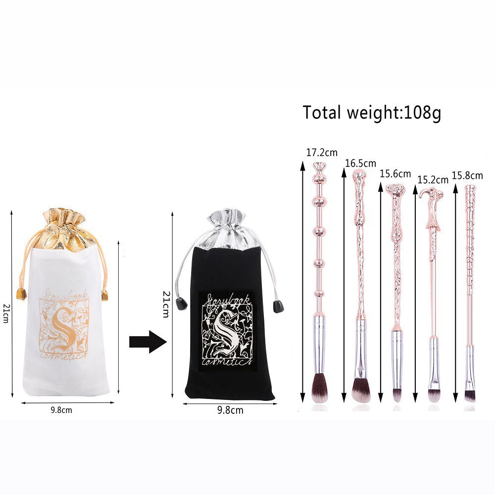 Five gunmetal silver wand brushes with dimension measurements (15.2cm–17.2cm) displayed beside the Storybook Cosmetics black velvet pouch with measurements (21cm x 9.8cm), total weight 108g