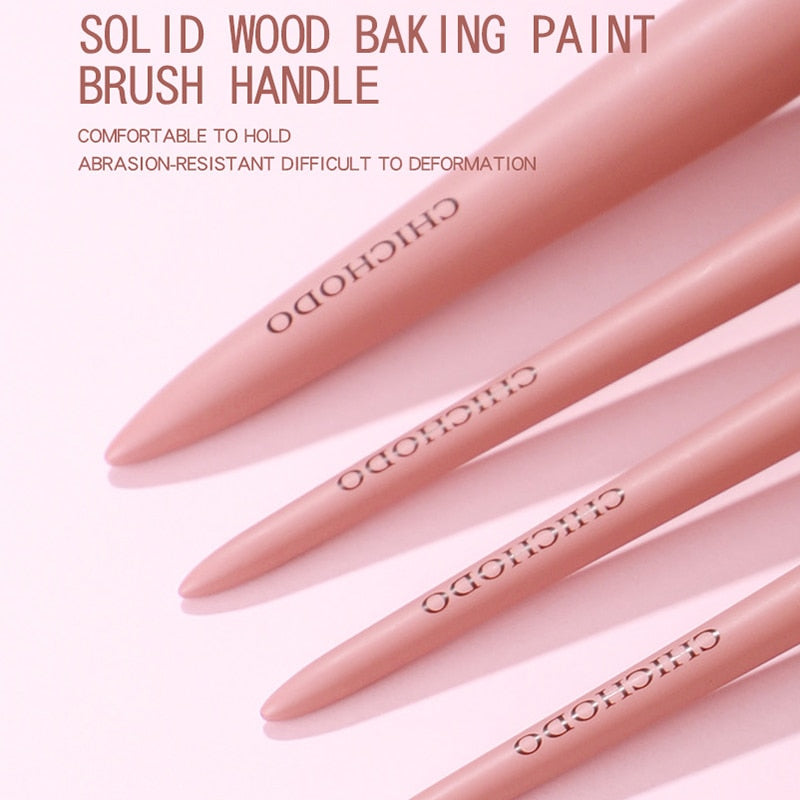 Hand holding soft synthetic fiber brush head showing texture and density of bristles