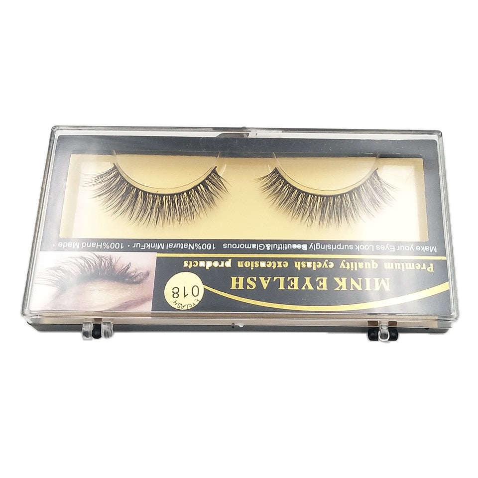 Open case view showing lashes mounted on cream silk bed with black cotton band and gold/black branded label visible inside lid