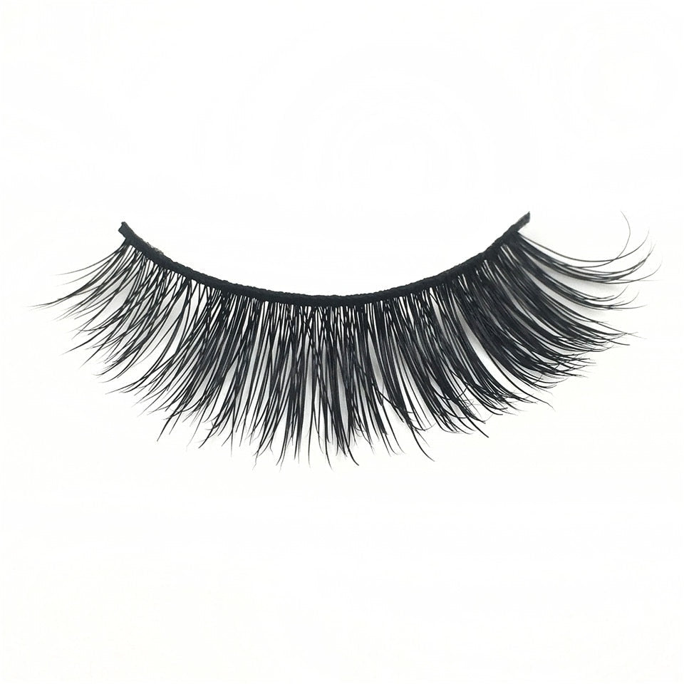 Isolated eyelash on white background showing the full feathered lash design from end to end