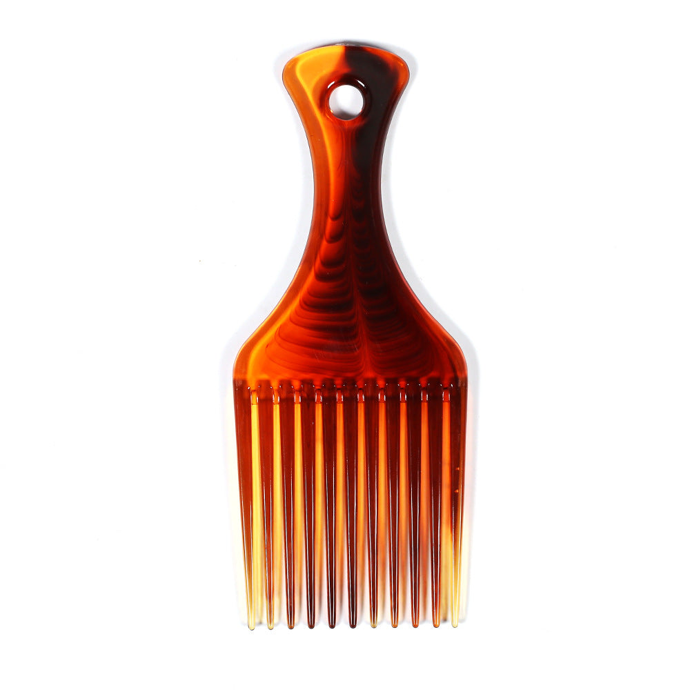 Front-facing flat lay of the tortoiseshell hair pick comb on a white background