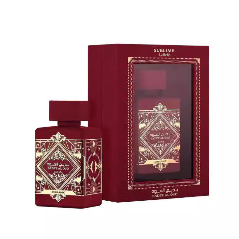 Bade'e Al Oud Sublime deep red bottle with gold Art Deco label beside its matching crimson window-display gift box on white background