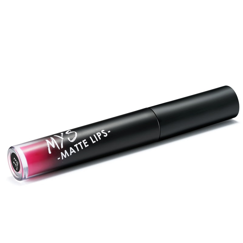 Single liquid lipstick tube at angle showing matte black exterior, white text, and transparent tip revealing pink-red liquid formula