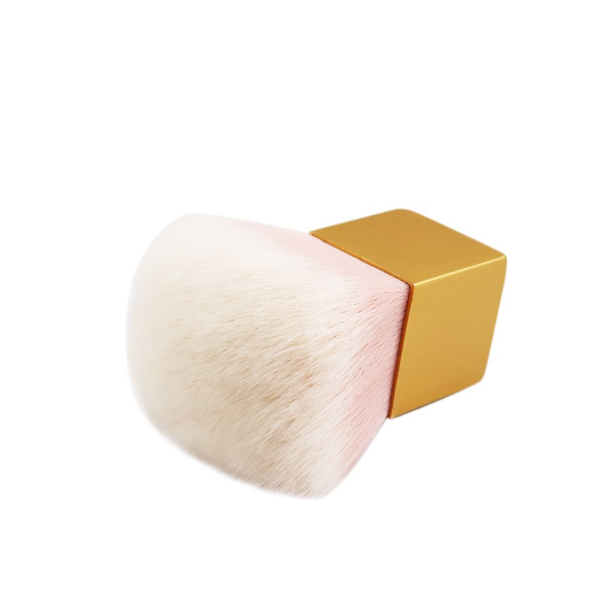 Side-angle close-up of the kabuki brush laying flat showing bristle density and gold aluminium ferrule