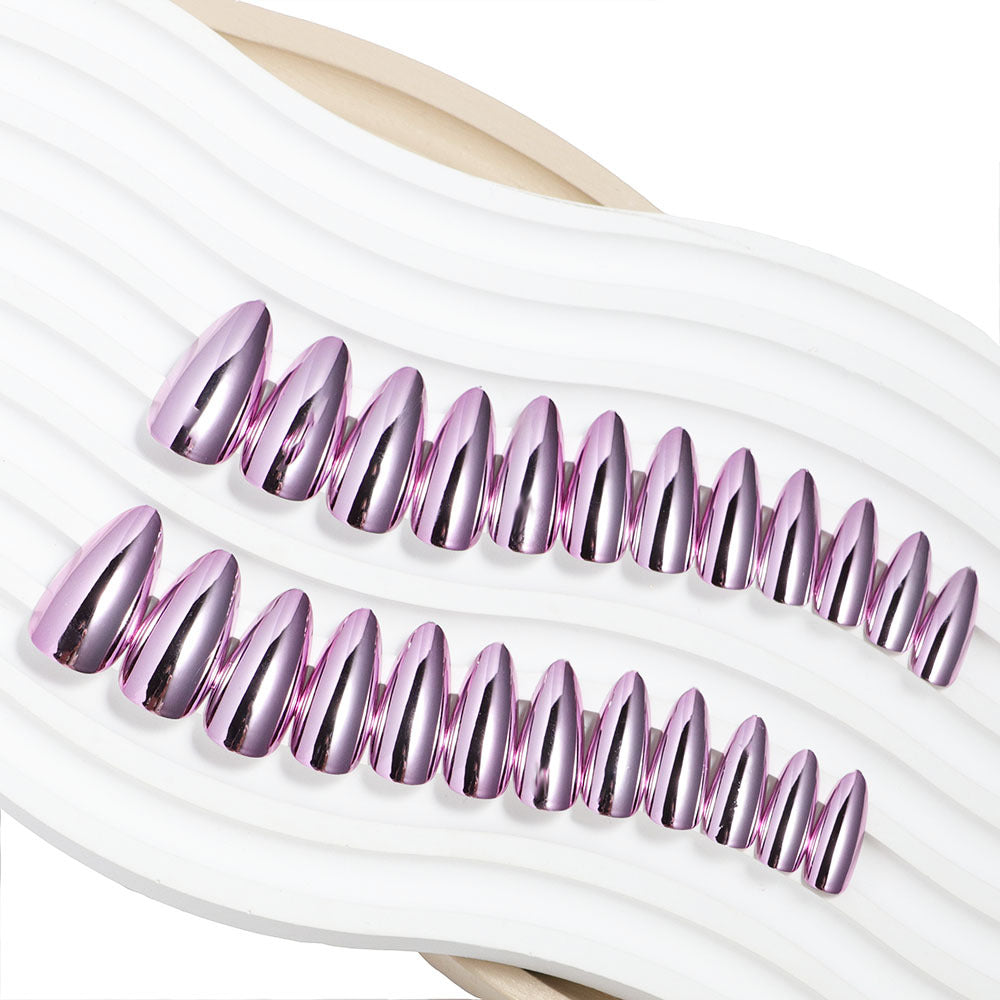 Product packaging showing multiple pre-glued nails in white blister pack with rose gold and mauve chrome designs