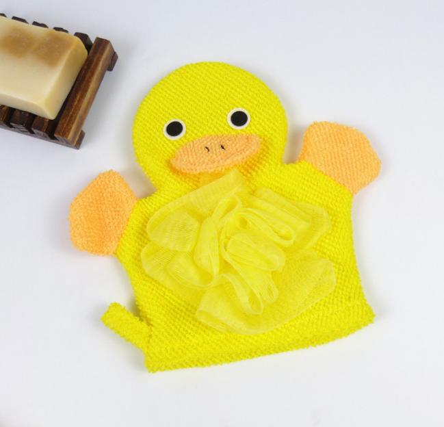 Yellow duck animal bath mitt glove with orange beak accents and yellow loofah puff next to a bar of soap