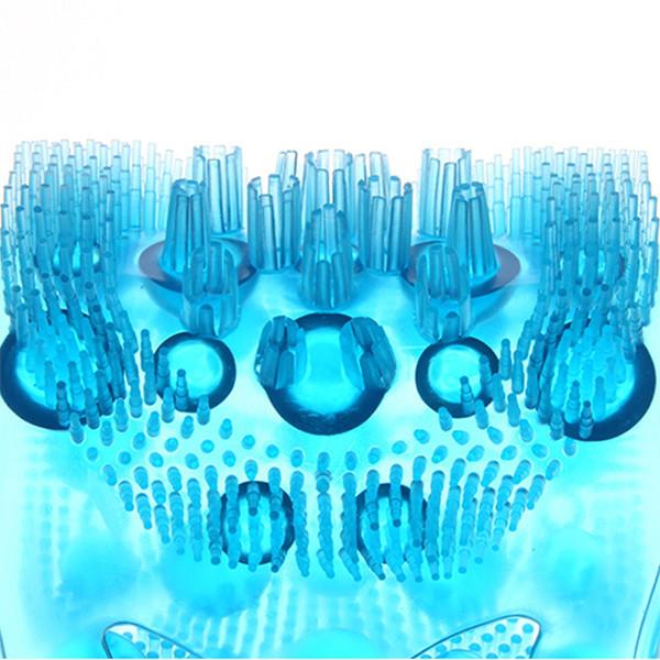 Extreme close-up of silicone bristle clusters and massage domes on the scrubbing surface