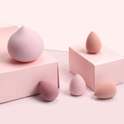 Pink makeup sponge set in clear cylindrical packaging with MAANGE branding and decorative striped design