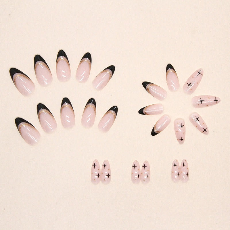 Clean white background flat-lay of all 24 press-on nail pieces in two rows showing size gradation from large to small, split between black French tip style and star motif style
