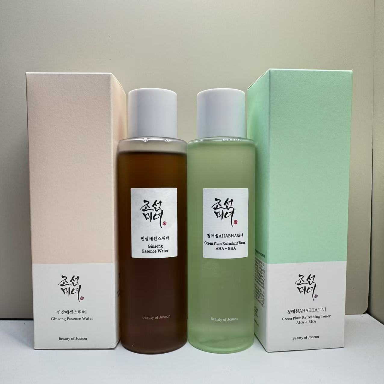Ginseng Essence Water and Green Plum Refreshing Toner AHA+BHA with their boxes displayed