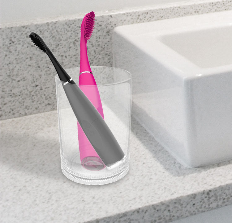 Black sonic toothbrush head detail and illustrations of tooth with healthy pink gums