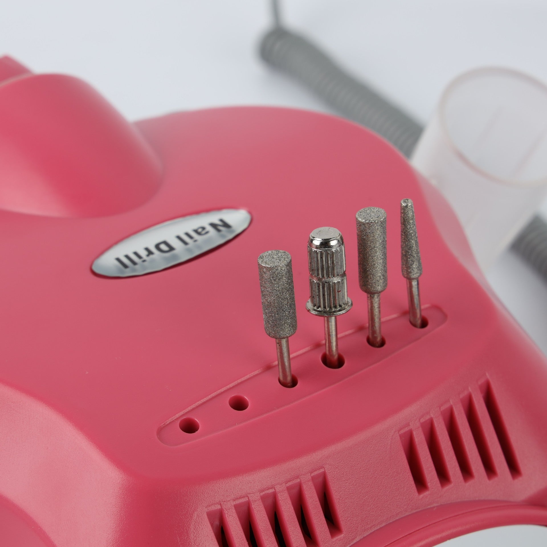 Side view of pink electric grinder with handpiece, power cord, and foot pedal control