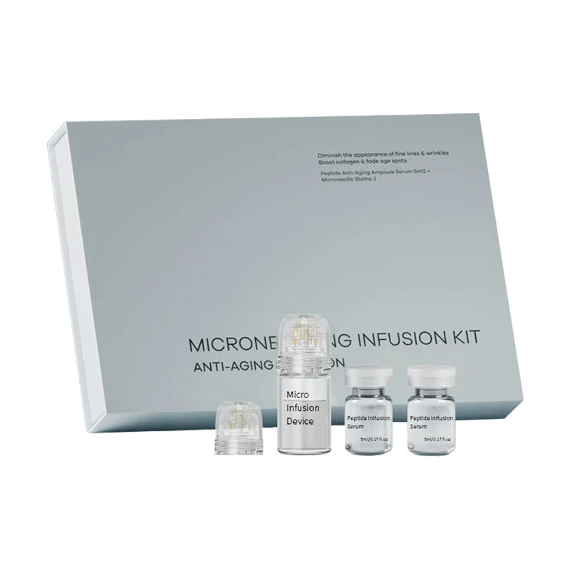 Complete kit unboxed on white surface: micro-infusion device, serum vials, luxury gray packaging box with product name